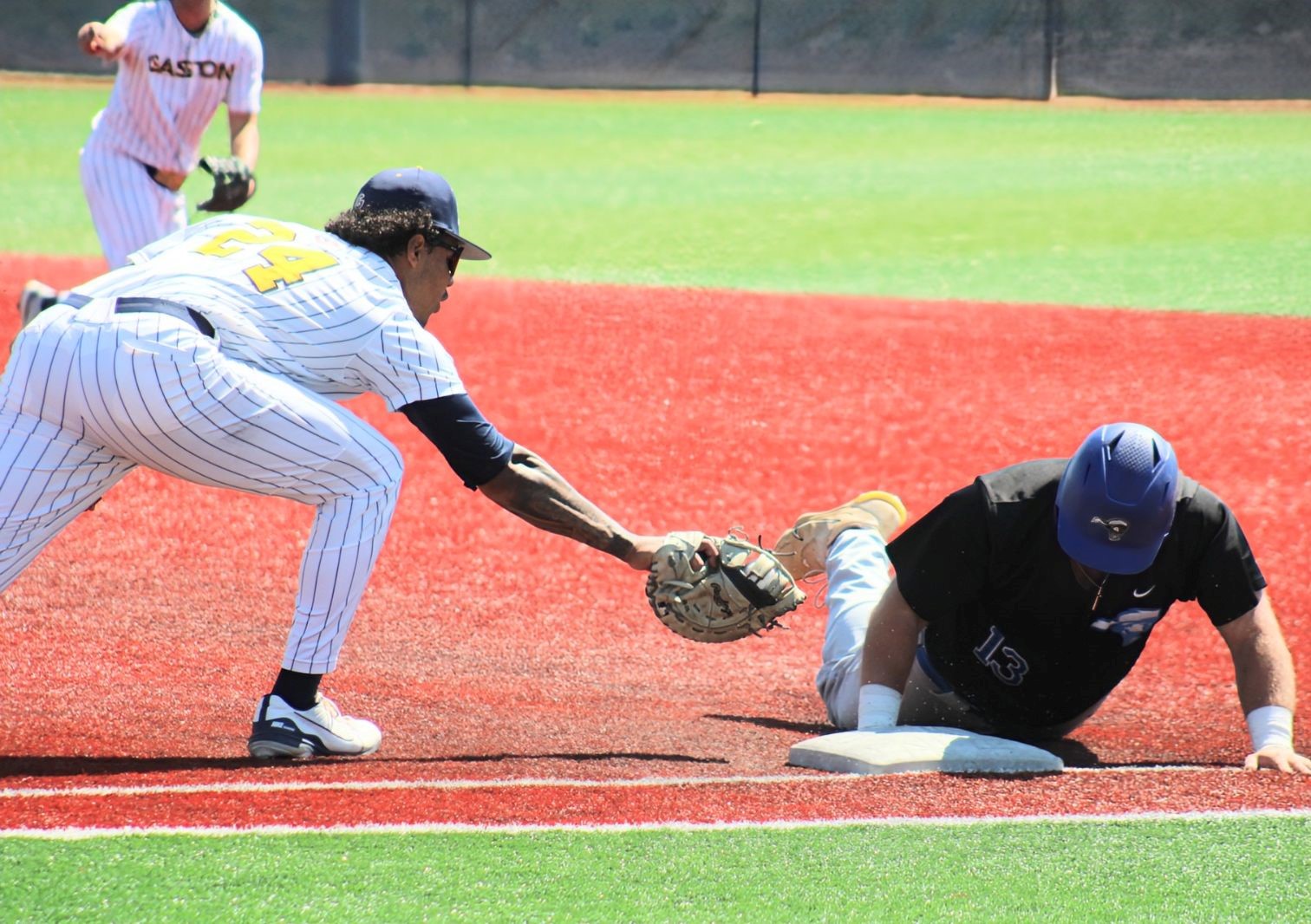 Gaston College first baseman Freddie Oliver (left) reaches to make a tag during Friday's doubleheader.