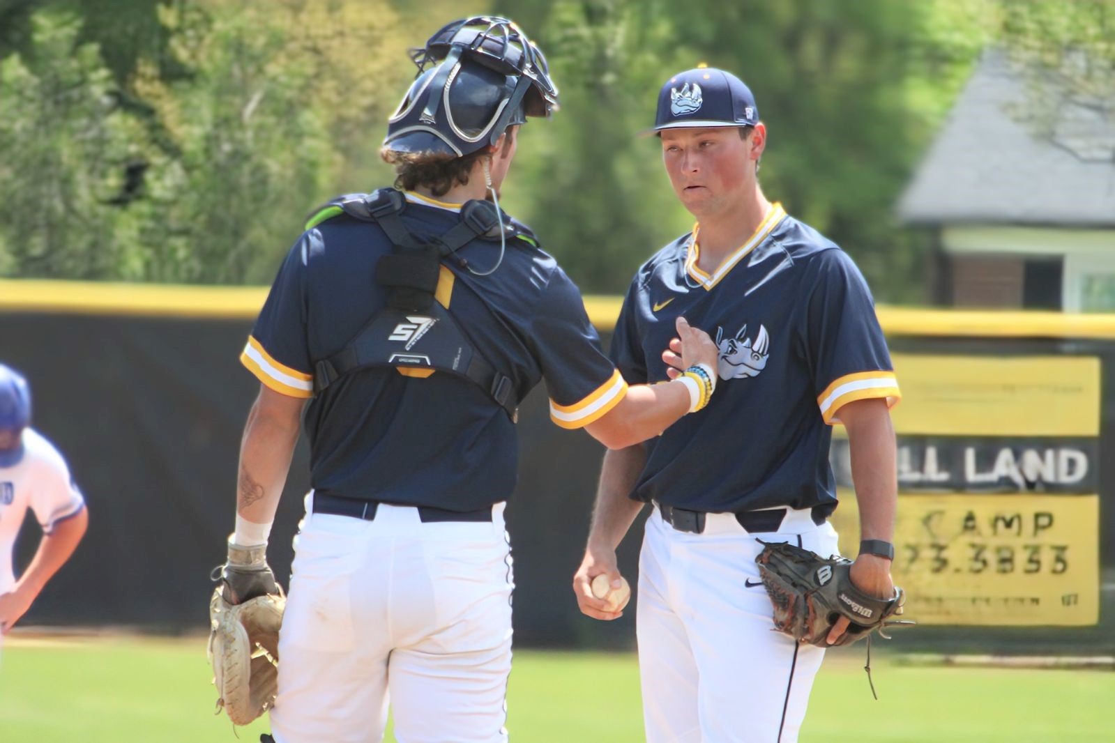 Gaston College catcher Seth Christmas (left) discusses strategy with pitcher Landon Carr during last Sunday's Rhinos victory at Cleveland Community College.