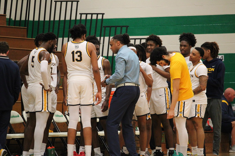 Gaston College interim head basketball coach Jermaine Williams (middle) talks to his team during last Wednesday's win over Richard Bland College.