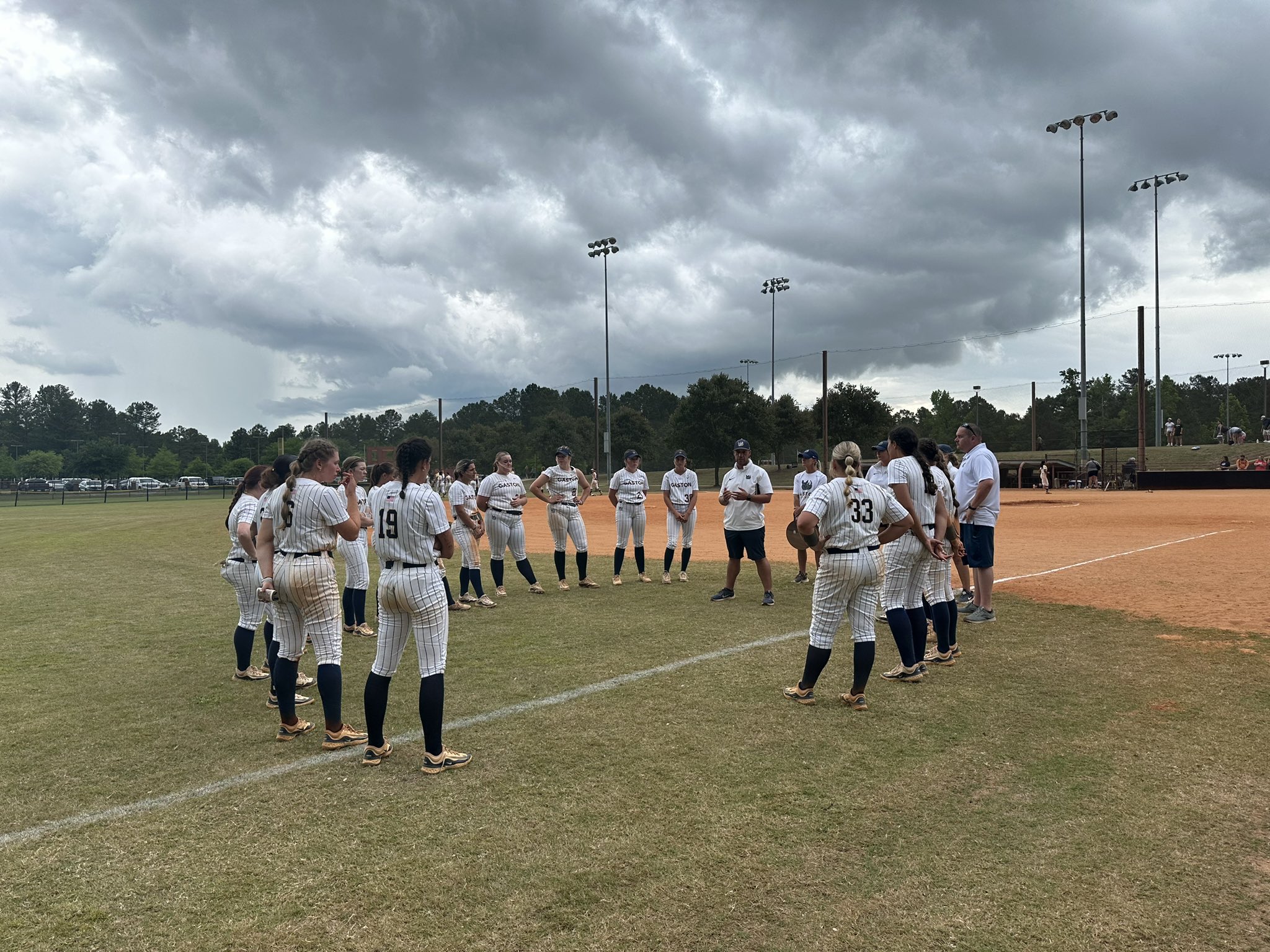 Gaston College softball meets in the outfield for the final time of the 2024 season after Saturday's game at Patriot Park in Sumter, S.C.