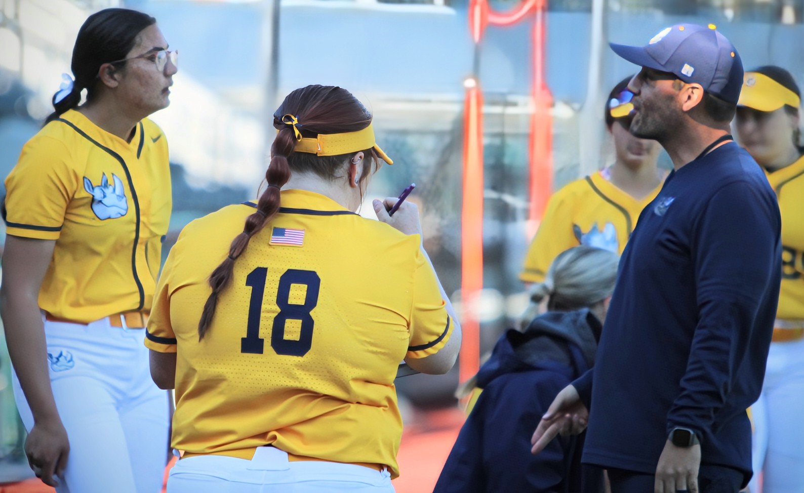 Gaston College coach Mike Steuerwald (right) discusses strategy with Abigail Gawlinski (left) and Tessa Hunt (18) during a game earlier this season.