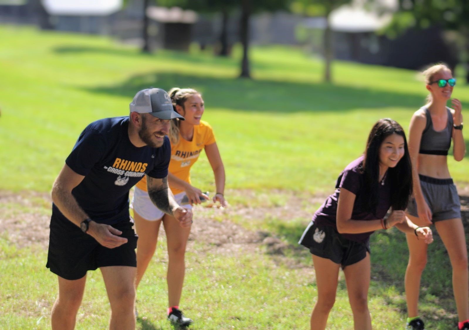 Gaston College women's cross country coach Kody Kubbs (far left) during a recent Rhinos' practice session.