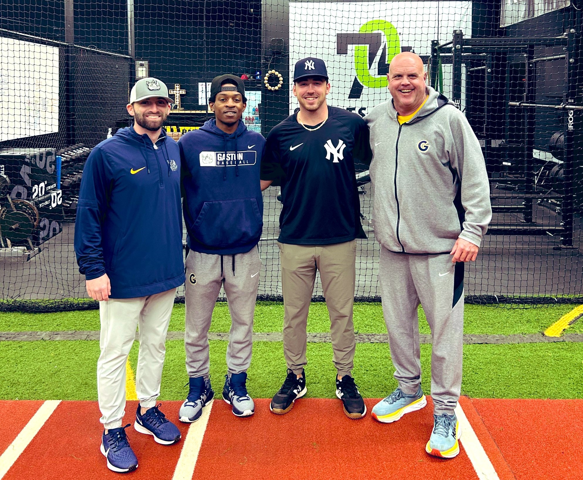 Former Gaston College pitcher Gus Hughes (second from right) poses with Rhinos coaches (left to right) Jacob Rand, K.J. McAllister and Shohn Doty during a workout session at Lowell's 704 Sports Academy.