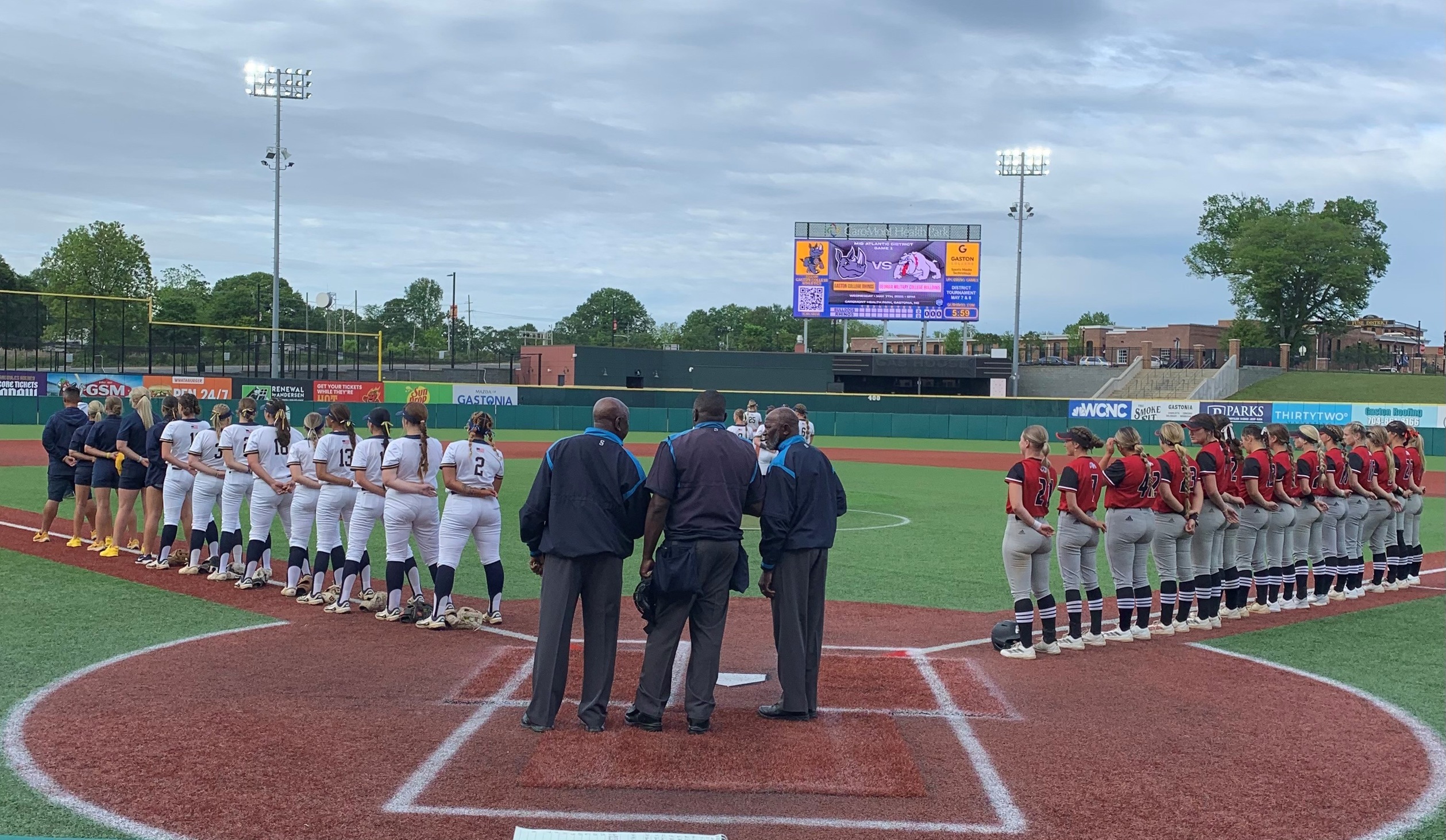 Gaston College (left) and Georgia Military (right) line up for the national anthem before Wednesday's Mid-Atlantic District opener at Gastonia's CaroMont Health Park.